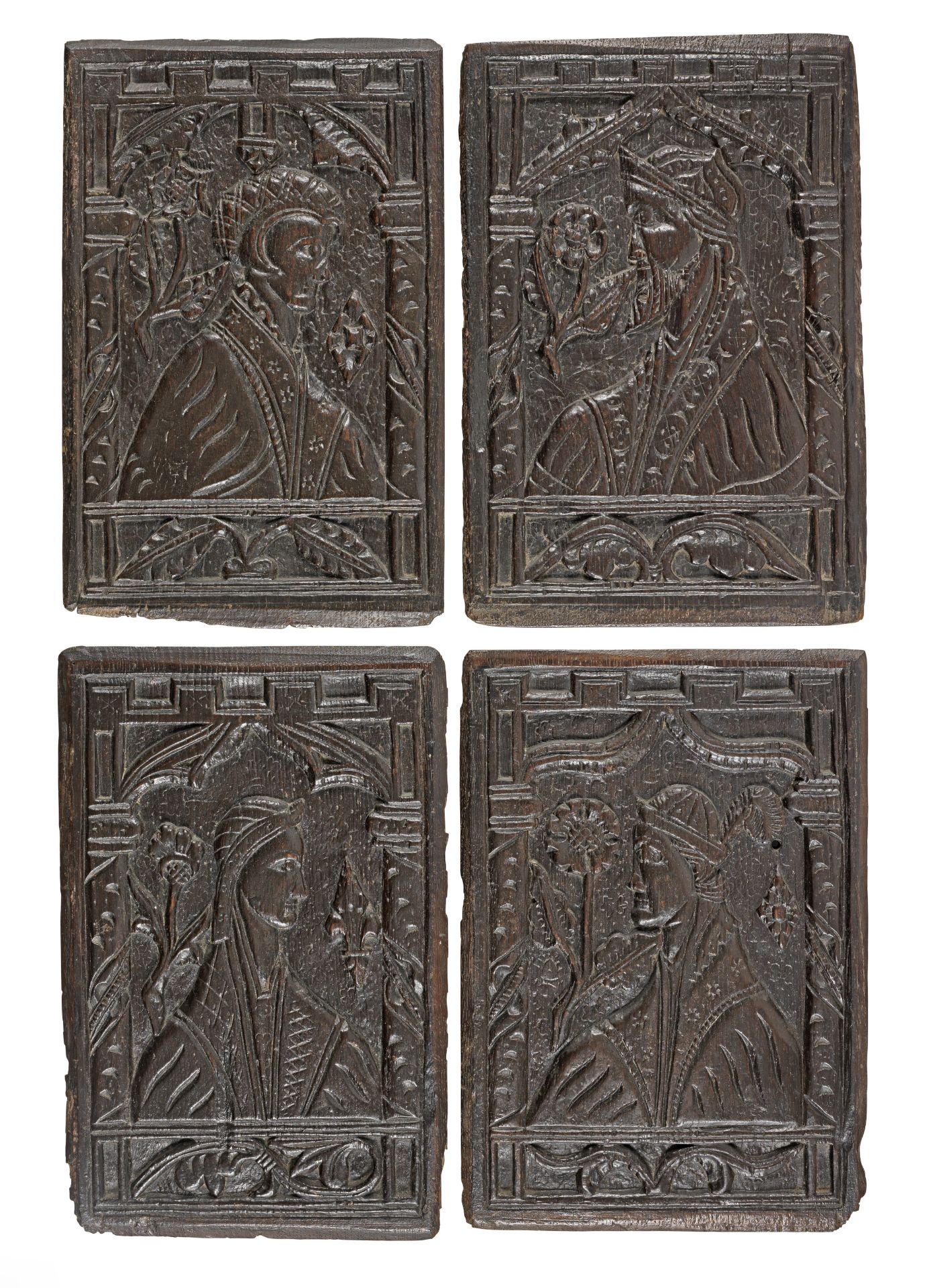 A rare set of four mid-16th century carved oak portrait panels, English, circa 1550 (4)