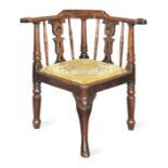 A George IV oak corner chair, English, circa 1830