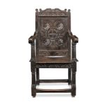 A documented and impressive Charles I joined oak panel-back open armchair, West Country, circa 1630