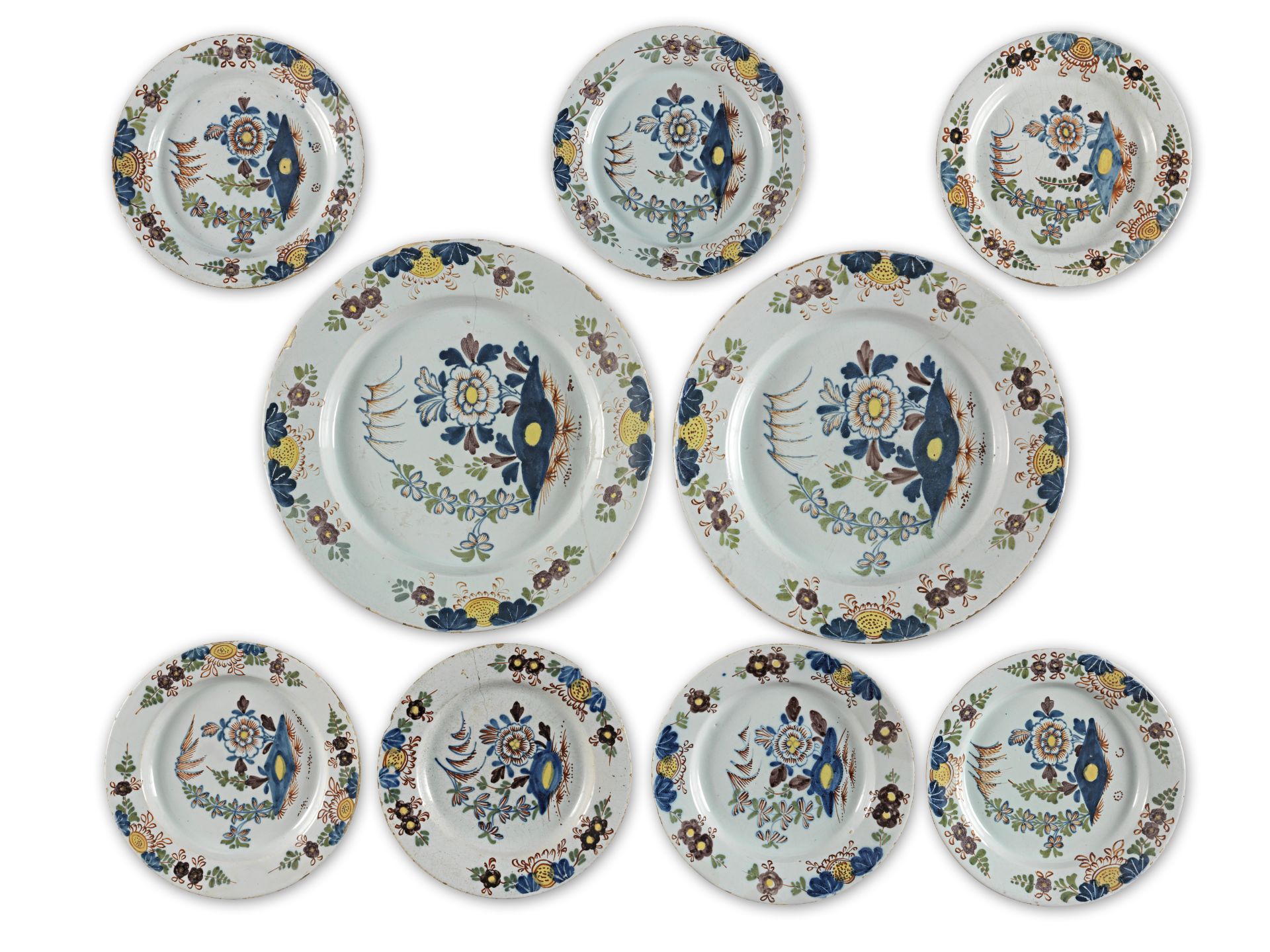 A pair of George III London (Lambeth) delft chargers, with seven similar plates, circa 1775 (9)