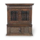 A rare Charles I joined and boarded oak, fruitwood and parquetry-inlaid mural livery cupboard, We...