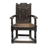 An extremely rare James VI of Scotland joined oak caqueteuse armchair, Fife, circa 1600