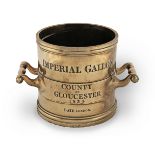 A William IV brass alloy Imperial Standard measure, of gallon capacity, for the County of Glouces...