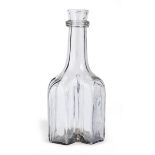 An early 18th century clear glass cruciform decanter, or serving bottle, English, circa 1700-30