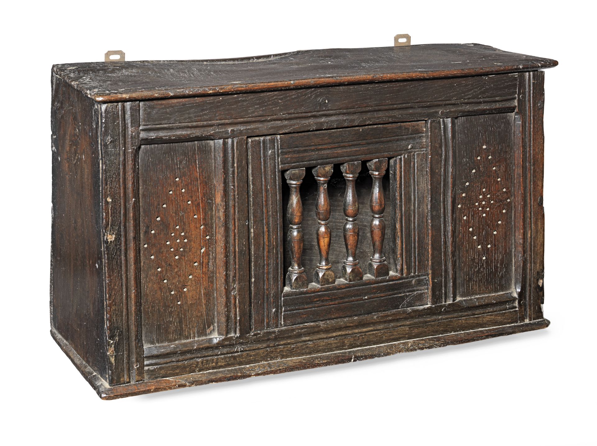 A small Charles II joined and boarded oak spindle mural livery cupboard, circa 1660