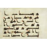 A leaf from a manuscript of the Qur'an written in kufic script on vellum Near East or North Afric...