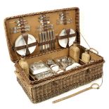 A wicker-cased 'Coracle' picnic set for six persons by G W Scott & Sons, circa 1909,