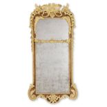 A 19th century walnut and parcel gilt mirror in the George II style