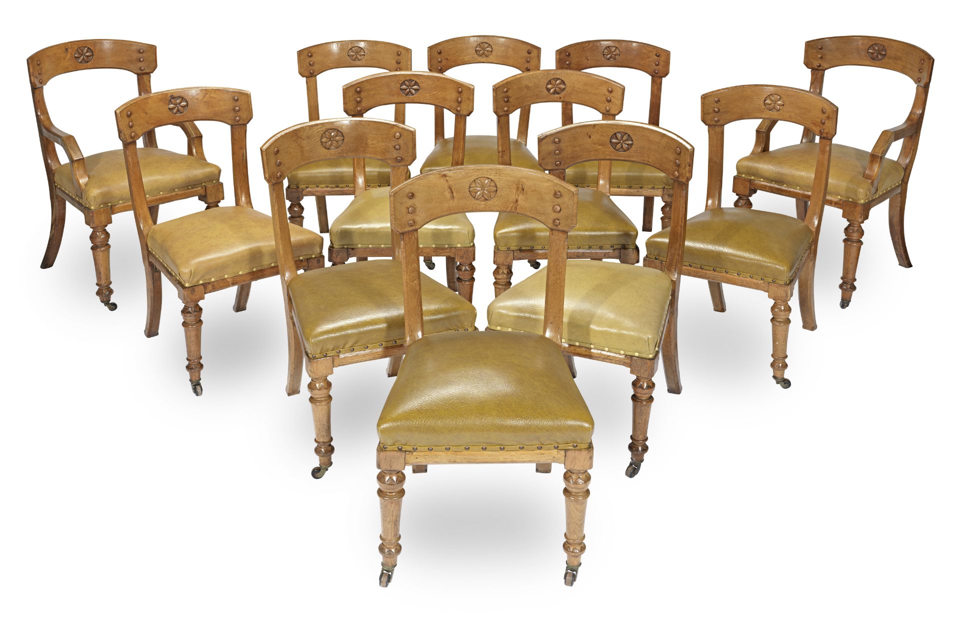 A set of twelve mid Victorian gothic revival oak dining chairs attributed to E.W. Pugin (12)