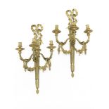 A pair of gilt bronze three-light wall appliques in the Louis XVI style, (2)