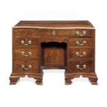 A George III mahogany and chequer inlaid serpentine kneehole writing/dressing table