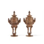 Two similar carved and turned stained lindenwood souvenir cups and covers (2)