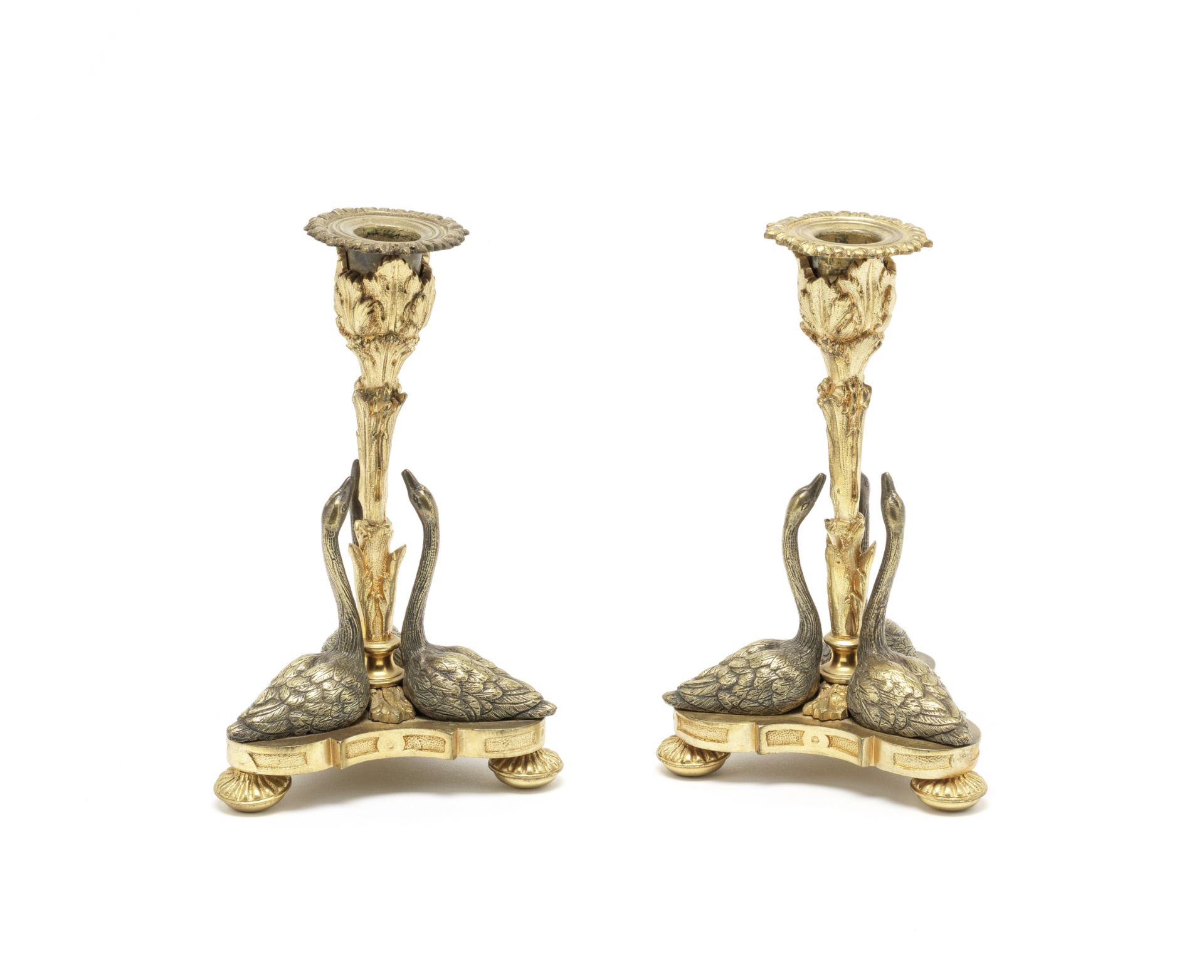 A pair of early Victorian silvered and parcel gilt swan candlesticks after a design by William Ba...