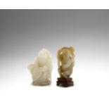 A white jade figure of Shoulao and deer and a pale green and mushroom jade monkey The Shoulao fig...