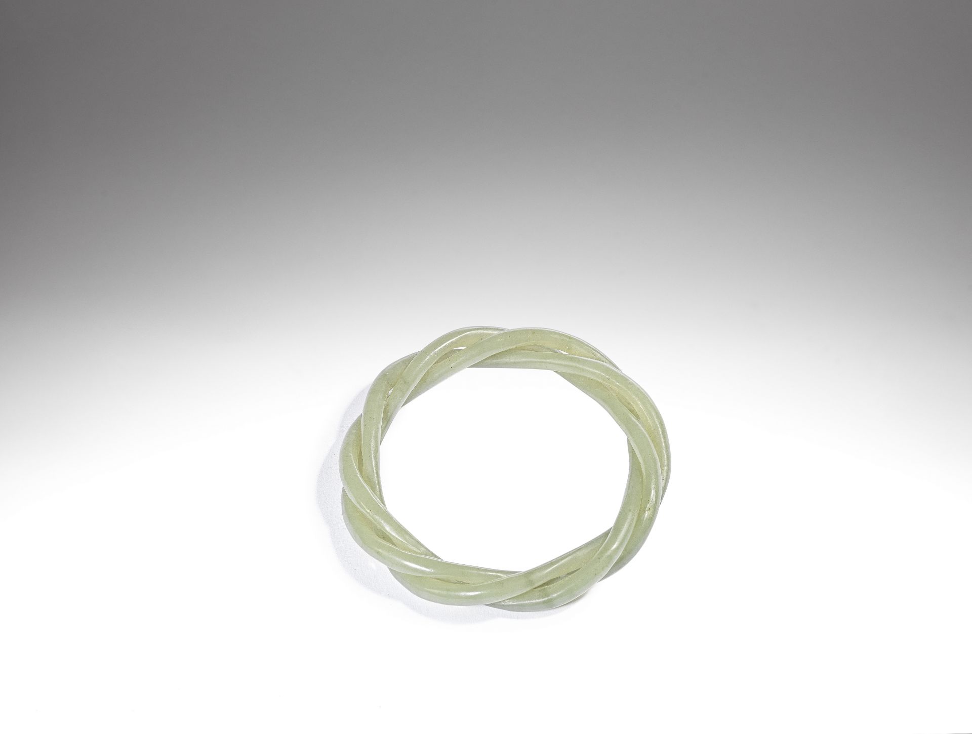 A green jade rope-twist bangle 19th century