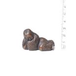 A wood netsuke of a sleeping Shojo By Ikkan (1817-1893), Nagoya, 19th century