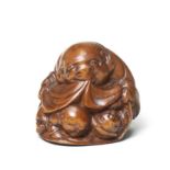 A wood netsuke of Hotei By Matsushita Otoman, Hakata, mid-19th century