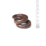 A boxwood netsuke of a coiled snake By Kashu, late 18th/early 19th century