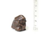 A compact wood netsuke of Daikoku By Nobuyuki, 19th century