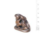 A boxwood netsuke of a snake and skull By Kawakata Masanori, late 19th century