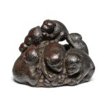 A wood netsuke of a group of monkeys By Tametaka, Nagoya, 18th century