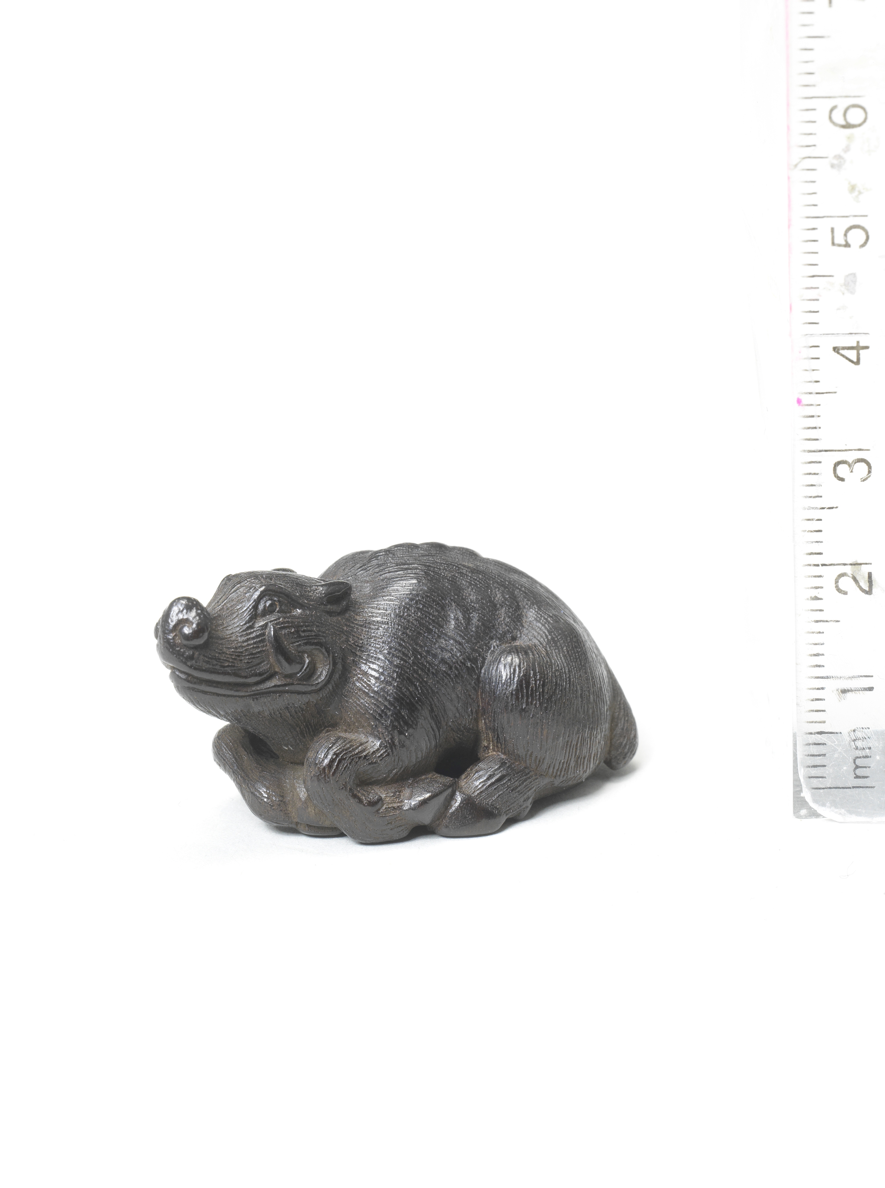 A wood netsuke of a recumbent boar By Kokei, Kuwana, Ise Province, late 18th century