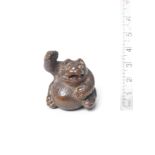 A wood netsuke of a tanuki By Tanaka Minko (1735-1816), Tsu, late 18th century