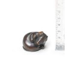 A wood netsuke of a rat with its head turned back By Ikkan (1817-1893), Nagoya, mid-19th century