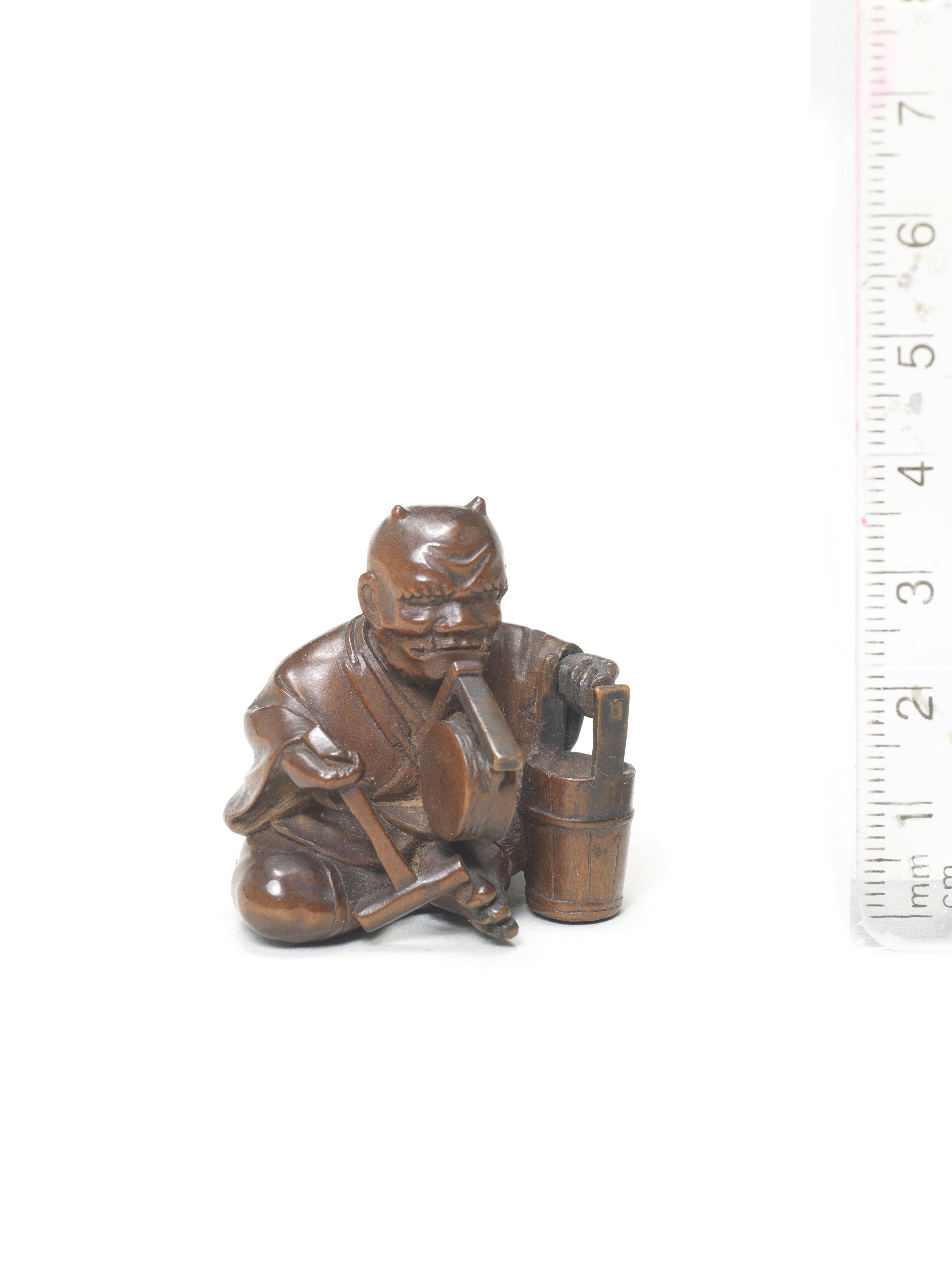 An okimono-style wood netsuke of oni no nenbutsu By Kyokumin, mid-late 19th century