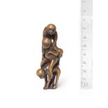 A wood netsuke of a pyramid of monkeys 18th century