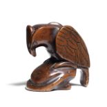 A wood netsuke of an eagle on a rock 18th century