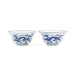 A near pair of blue and white 'dragon' bowls Qianlong seal marks and of the period (4)