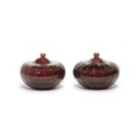 A pair of Imperial ruby-red melon-shaped glass jars and covers Qianlong four-character marks and ...
