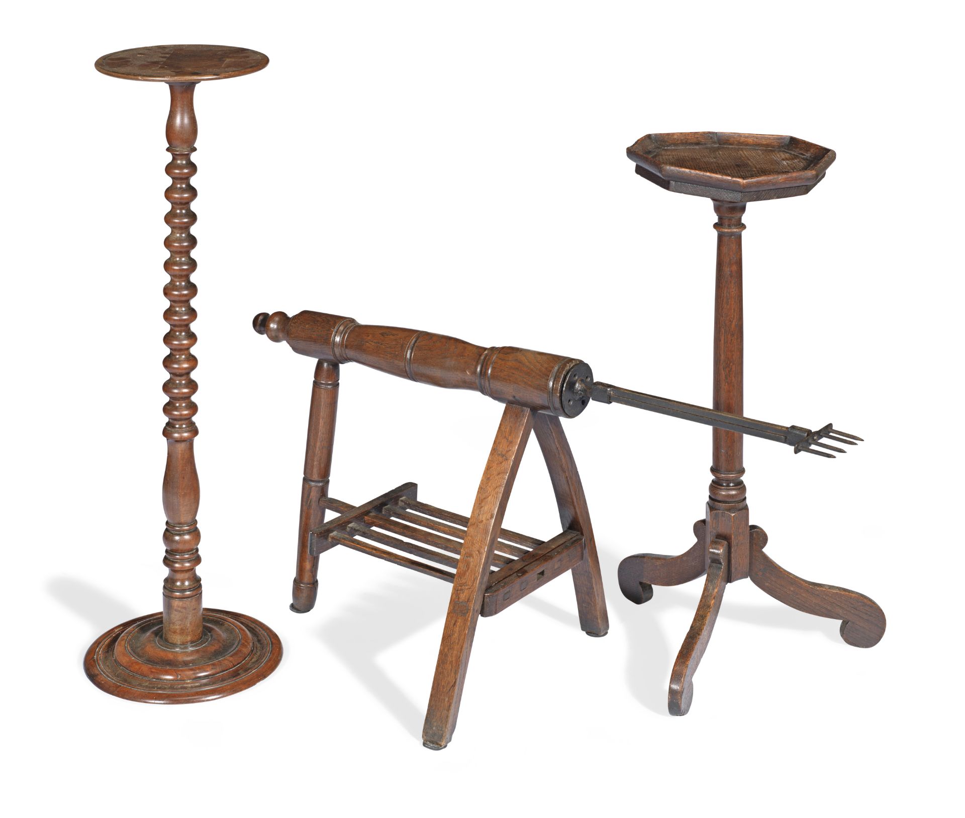 An elm and wrought iron roasting spit together with an 18th century oak candle or urn stand and a...