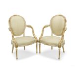 A pair of George III painted and parcel gilt armchairs In the Louis XVI style (2)