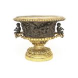 A late 19th century gilt and patinated bronze and metal urn