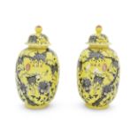 A pair of yellow ground and grisaille enamelled oviform jars and covers (2)