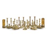 A collection of 20 18th century and early 19th century brass candlesticks