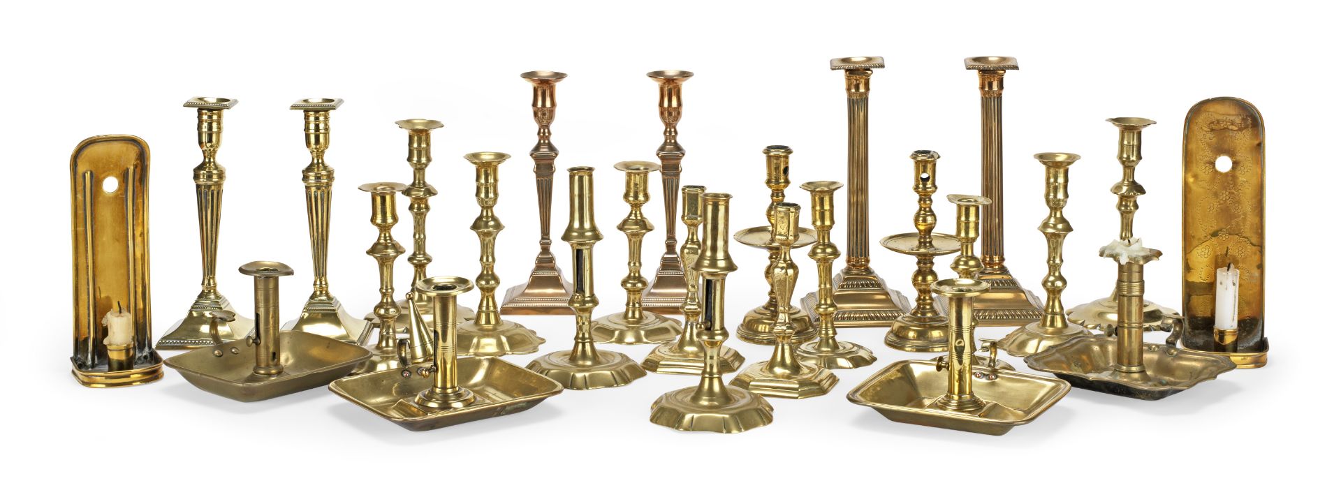 A collection of 20 18th century and early 19th century brass candlesticks