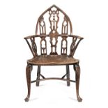 A 18th century yew and elm Gothic Windsor armchair