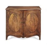 A George III mahogany and rosewood banded serpentine commode In the manner of Thomas Chippendale