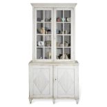 A Gustavian style painted bookcase enclosing a collection of natural history specimens and potter...