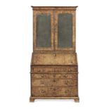 A George I and later walnut and crossbanded bureau cabinet
