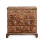 A Queen Anne walnut and feather banded bachelor's chest