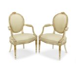 A pair of George III painted and parcel gilt decorated armchairs In the manner of Thomas Chippend...