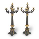 A pair of Charles X patinated and gilt bronze four branch candelabra