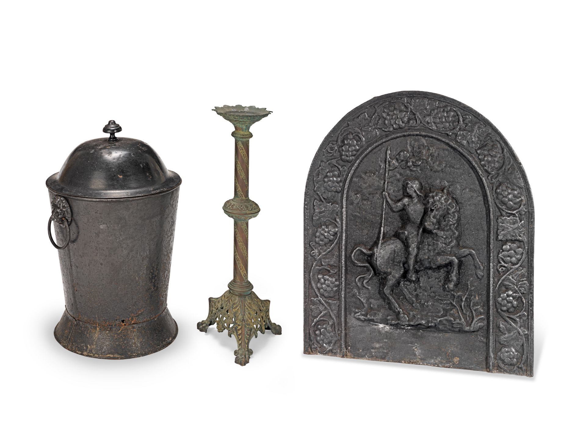 A Victorian cast metal pricket candlestick together with a cast iron fire back and a painted tole...