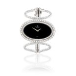 Montre Royale. An 18K white gold and diamond set manual wind oval bracelet bangle watch Ref: 5703...