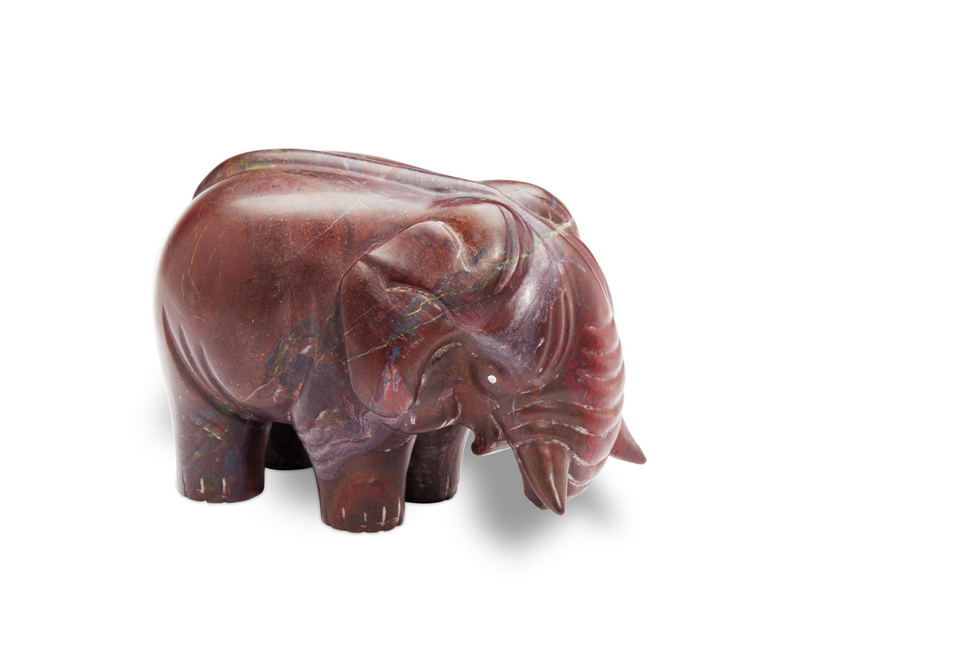 A red hardstone model of an elephantattributed to Fabergé, circa 1900