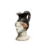 A Greek pottery figural oinochoe